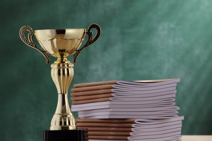 close-up-of-trophy-by-books-stockpack-istock Close-Up Of Trophy By Books