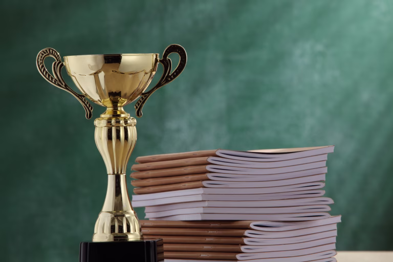 Close-Up Of Trophy By Books