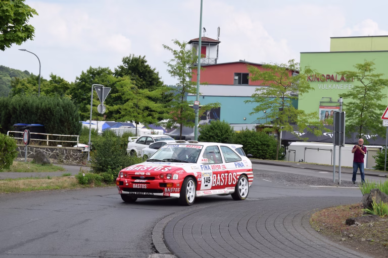 Daun, Germany - July 25/2025: Eifel Rally festival with vintage rally cars on public roads in the Eifel, Ford Escort Cosworth Gr.A Rally car in a traffic circle