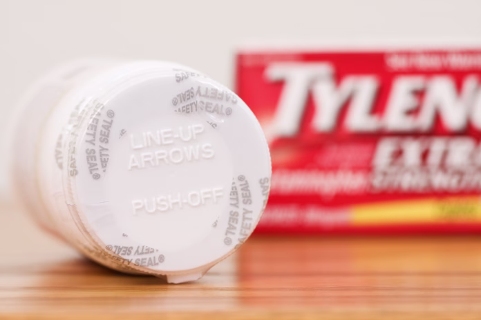 Fosston, USA - February 14, 2011: Close-up view of an unbroken Safety Seal and opening instructions on the lid of a bottle of Tylenol Extra Strength Acetaminophen Caplets. The bottle contains 100 caplets, 500 mg each. The original box / packaging is in the background. Manufactured by: McNeil Healthcare LLC Las Piedras, Puerto Rico For: McNeil Consumer Healthcare, Division of McNeil - PPC, Inc. Fort Washington, PA, USA.