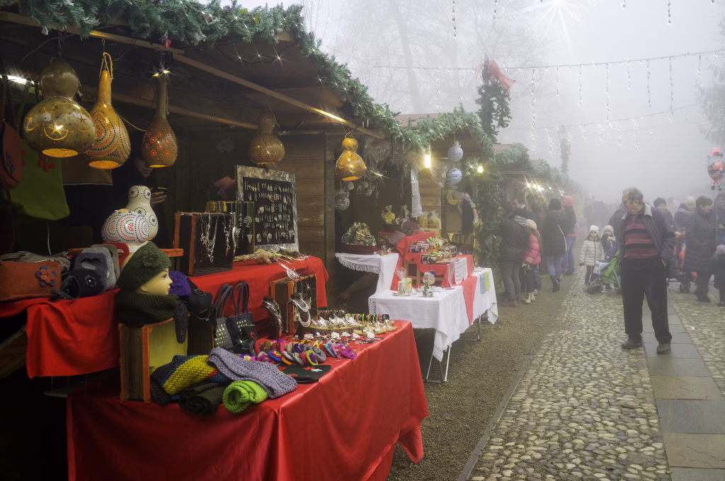 Govone, Italy - December 20, 2014: view of the typical Christmas markets of Govone (Cuneo). Some people are walking and give a look at the market stalls. Photo taken in a public area.