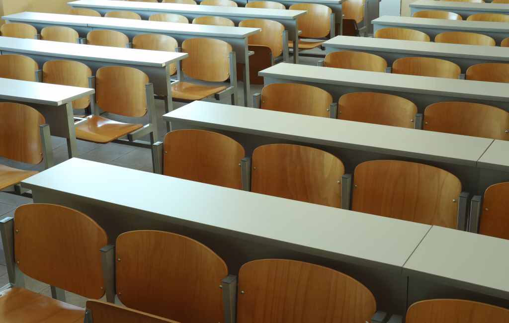 Here are wooden empty seats in lecture hall.