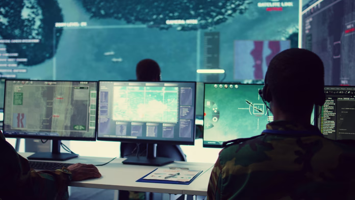 Military personnel employing the army satellite reconnaissance system to find any enemy warships or dangerous vessels. Navy IT engineers working in monitoring room general headquarters. Camera B.