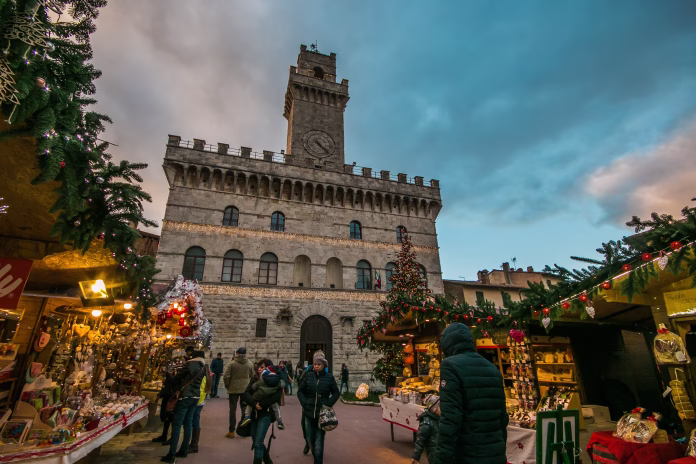 Montepulciano, Italy - November 18, 2017: Enchanted atmosphere at the Christmas market in the historic center of Montepulciano with big xmas tree, Tuscany