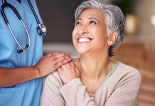 Zdravniki ob prihajajočem referendumu: »Ne želimo moralizirati« Nurse, senior woman and smile with comfort, holding hands or support in nursing home for retirement. Doctor, medic or caregiver with kindness, empathy or gratitude for help, trust or service in house