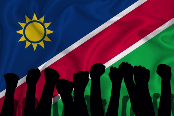Silhouette of raised arms and clenched fists on the background of the flag of Namibia. The concept of power,  conflict. With place for your text. 3D rendering