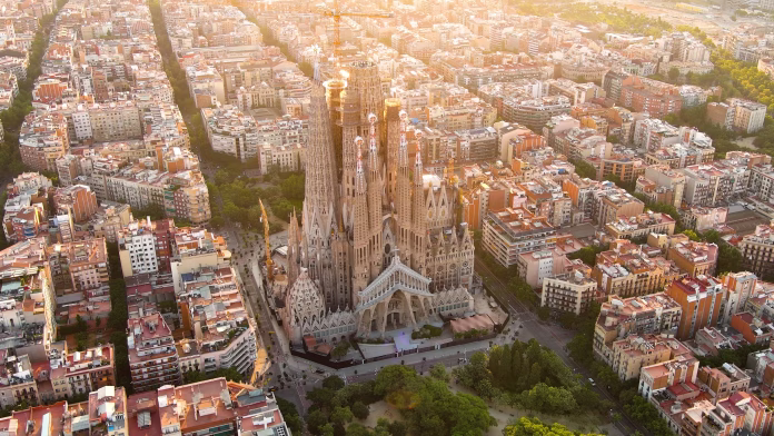 Temple Expiatori La Sagrada Familia in Barcelona, Catalonia, Spain. Flying around the architectural masterpiece of Gaudi at sunrise.