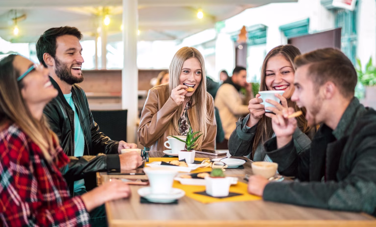 Friends group drinking cappuccino at coffee bar - People talking and having fun together at fancy cafeteria - Friendship concept with happy guys and girls at restaurant cafe - Warm bulb light filter