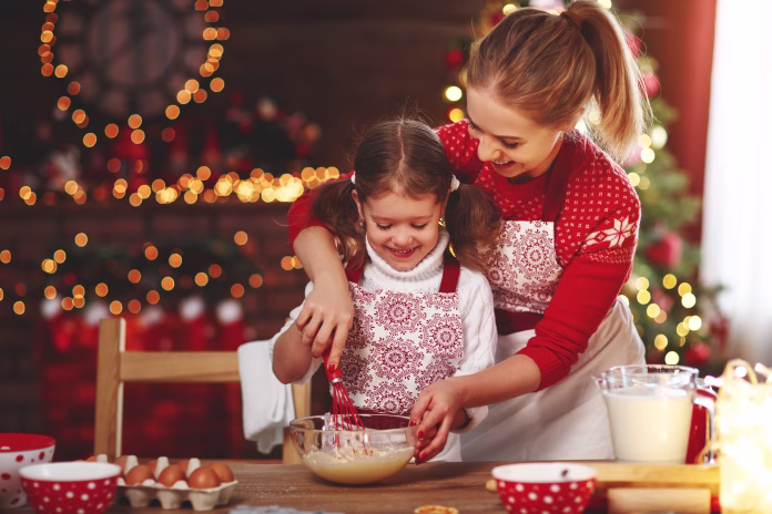 happy funny mother and child bake christmas cookies