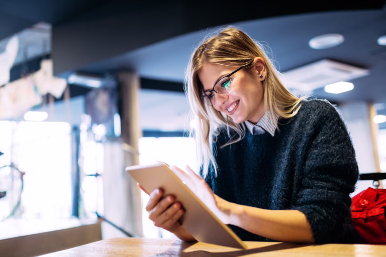 Portrait of young attractive woman using digital tablet