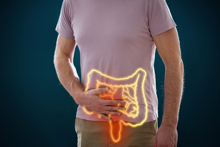 The man holding his stomach in pain. Male body with a picture of a digestive system and intestines with inflammation. Medical concept