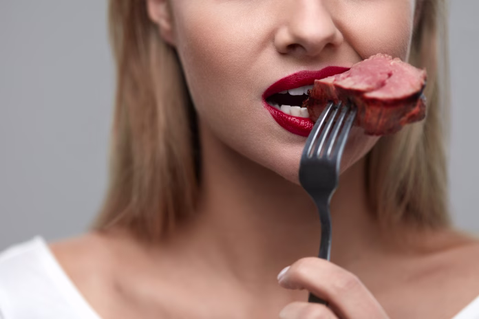 woman-eating-meat-closeup-of-healthy-hungry-girl-with-beautiful-face-red-lips-eats-delicious-grilled-meat-female-mouth-biting-piece-of-tasty-beef-steak-on-fork-nutrition-concept-high-resolution-stockpack-istock Woman Eating Meat. Closeup of Healthy Hungry Girl With Beautiful Face, Red Lips Eats Delicious Grilled Meat. Female Mouth Biting Piece Of Tasty Beef Steak On Fork. Nutrition Concept. High Resolution