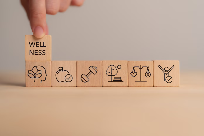 Holistic Wellness Concept. Wooden block with wellness icons, health care ,including mental well-being, fitness, nutrition, sleep, relationships and financial balance. Personal development and balance.