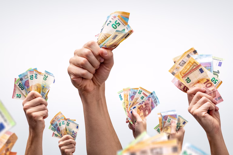 Many hands holding several Euro banknotes. Isolated on a neutral background.