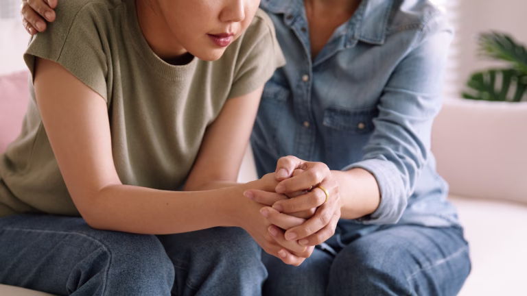 Middle aged asia people old mom holding hands trust comfort help young woman talk crying stress relief at home. Mum as friend love care hold hand adult child feel pain sad worry of life crisis issues.
