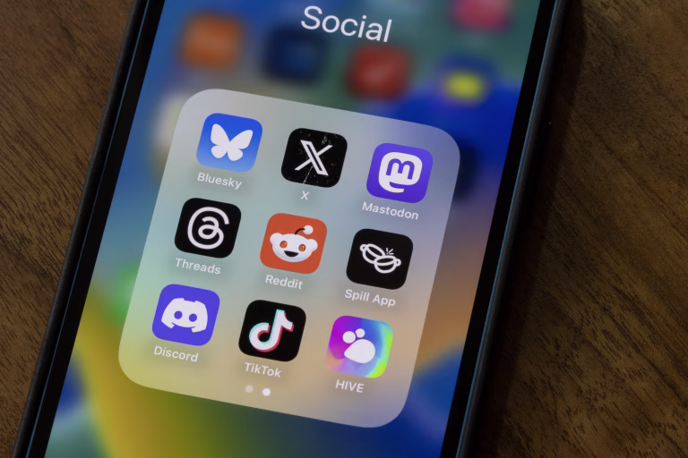 Portland, OR, USA - Apr 1, 2025: Assorted social networking apps, including Bluesky, X, Mastodon, Threads, Reddit, Spill, Discord, TikTok, and HIVE, are seen on the screen of an iPhone.