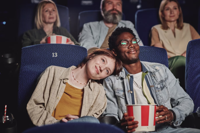 portrait-of-modern-lovey-dovey-ethnically-diverse-young-couple-spending-evening-on-date-at-cinema-stockpack-istock Portrait of modern lovey-dovey ethnically diverse young couple spending evening on date at cinema