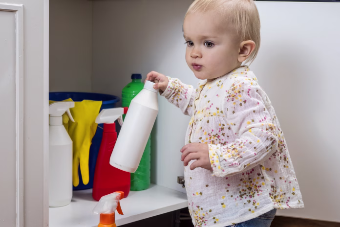 toddler-playing-with-household-cleaners-at-home-stockpack-istock Toddler playing with household cleaners at home