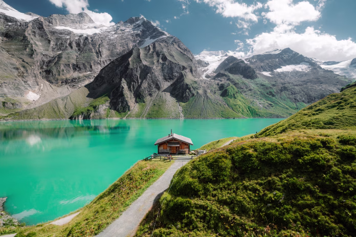 Beautiful alpine mountain scenery with traditional wooden mountain hut at Mooserboden high-mountain water reservoir lakes in Nationalpak Hohe Tauern, Salzburg Land, Austria