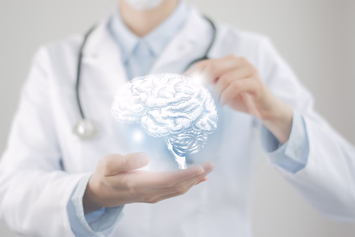 Female doctor holding virtual volumetric drawing of Brain in hand. Handrawn human organ, copy space on right side, raw photo colors. Healthcare hospital service concept stock photo