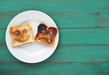 TikTok teorija zažganega toasta vam lahko pomaga v težkih trenutkih Flat lay view of two slices of toasted bread in a white plate. One is burned and one is well done. Relationship lifestyle concept. copy space