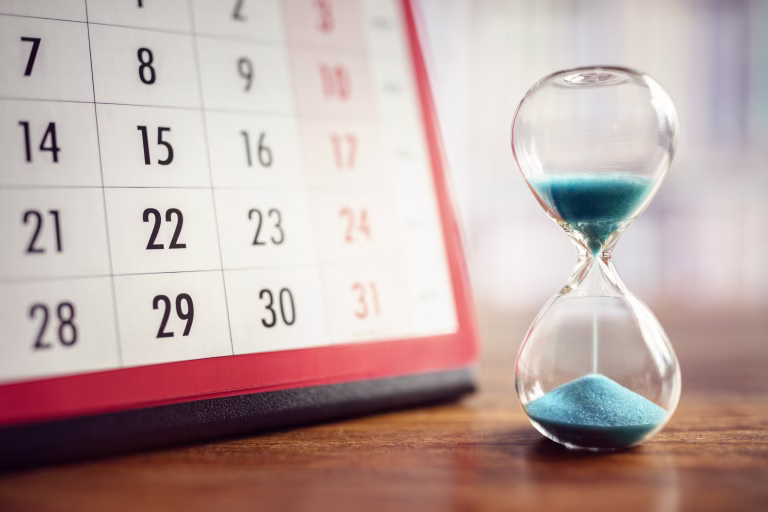 Hour glass and calendar concept for time slipping away for important appointment date, schedule and deadline