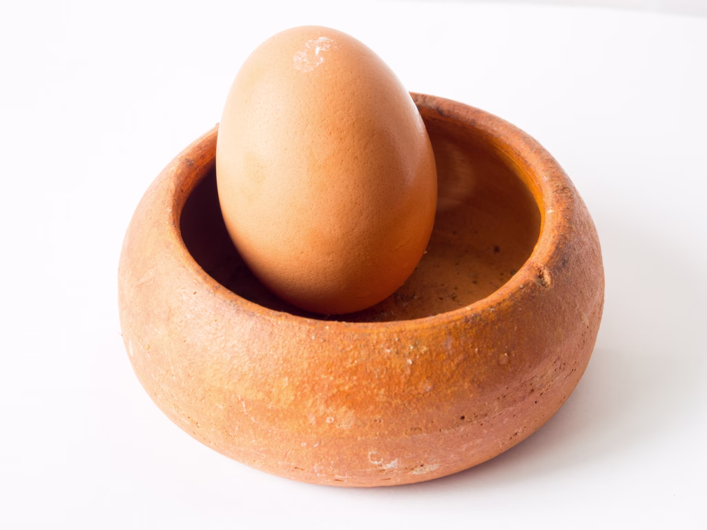 Light Brown of Chicken egg Placed in a brown pottery bowl.