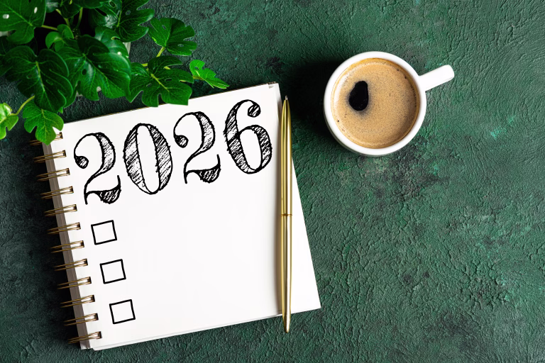 New year resolutions 2026 on desk. 2026 resolutions list with notebook, coffee cup on table. Goals, resolutions, plan, action, checklist concept. New Year 2026 template, copy space