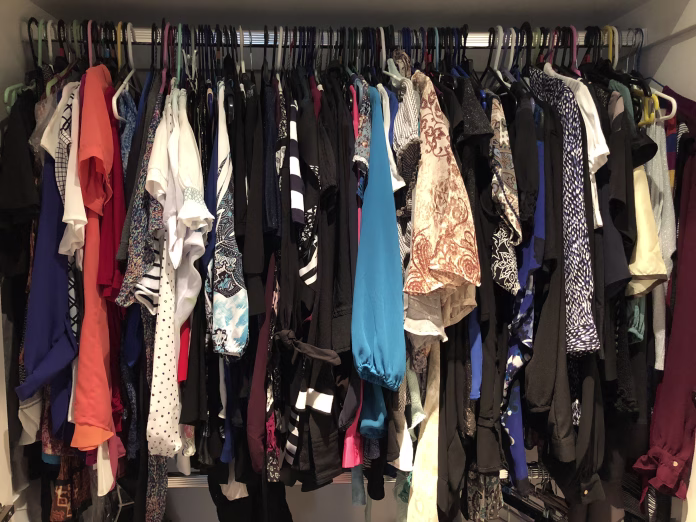 Overflowing closet full of women’s clothes