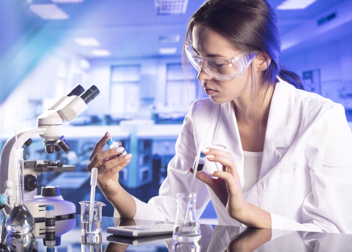 Young female scientist working in laboratory.
