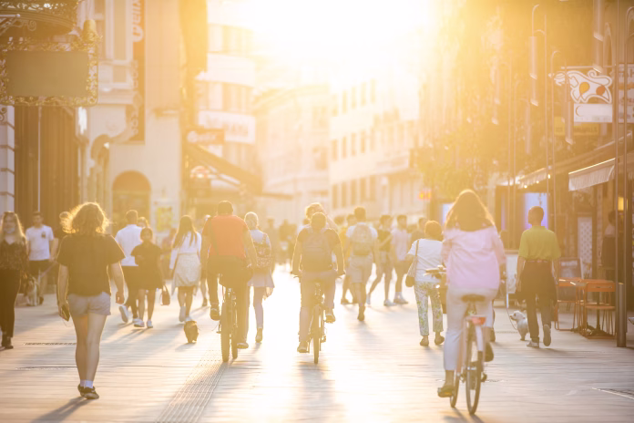 Blurred crowd of people on Copova pedestrian street in Ljubljana at sunset. Urban lifestyle and mobility concept