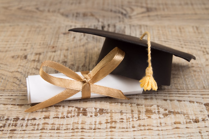 Law concept - Open law book with a wooden judges gavel on table in a courtroom or law enforcement office on blue background. Copy space for text