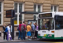 Sodišče odločilo, če je bil dvig cen LPP vozovnic ustaven Ljubljana, Slovenia - july 26, 2011: A view of the people in line and slowly going on the bus at bus station in front of main Post office in center of Ljubljana. On left side is panelwith bus line nimber and time when it will leave.