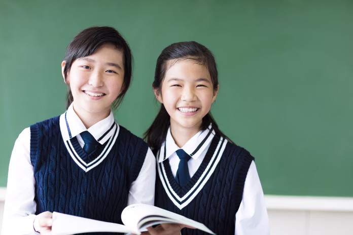smiling teenager student girls in classroom