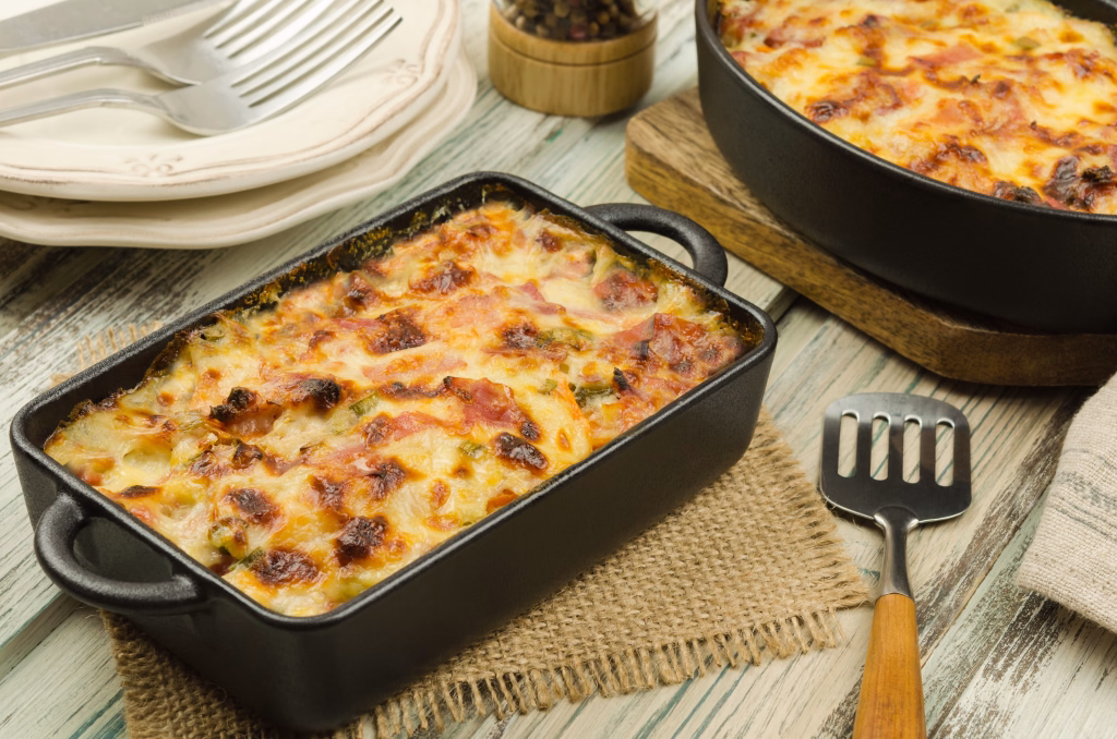 Tartiflette: baked potatoes with bacon and cheese close up.