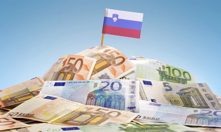 The national flag of Slovenia sticking in a pile of mixed european banknotes.(series)