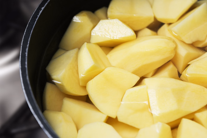 bright-yellow-vegetable-pieces-on-metal-stove-closeup-food-background-stockpack-istock Bright yellow vegetable pieces on metal stove. Closeup food background.