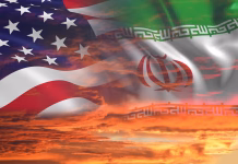 Komentar: Odločitev, ki bo Trumpa stala zapuščine? USA United States of America and Iran relations / iran us war with flags on stormy cloudy orange sky background