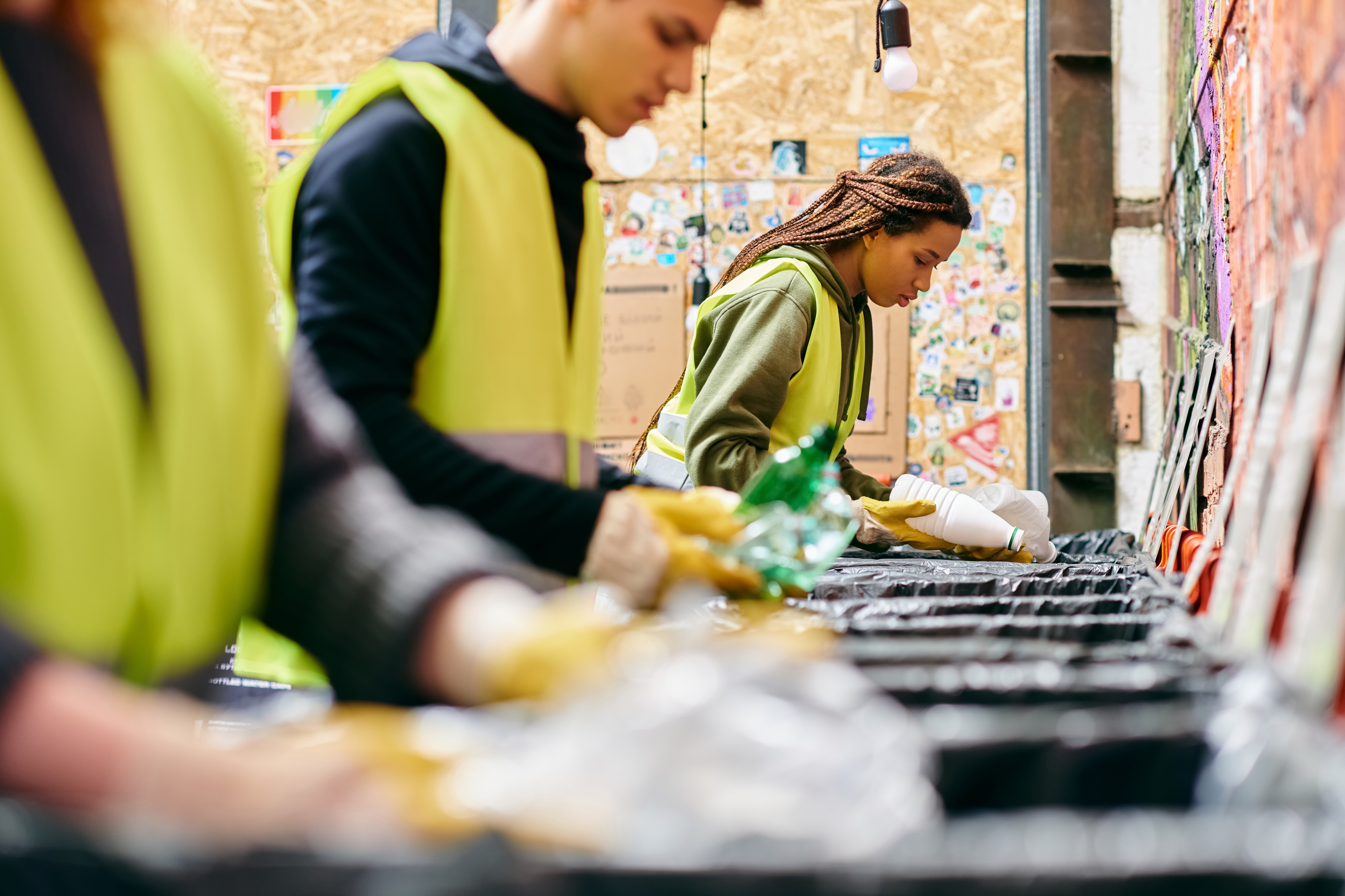 A group of dedicated volunteers diligently sorts recyclable items at a community center, promoting sustainability.