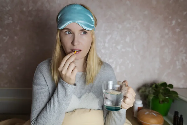 A woman cannot fall asleep and wants to drink a capsule with melatonin, a sleeping pill. Regulation of biological rhythms. Manifestations of jitlag or insomnia.