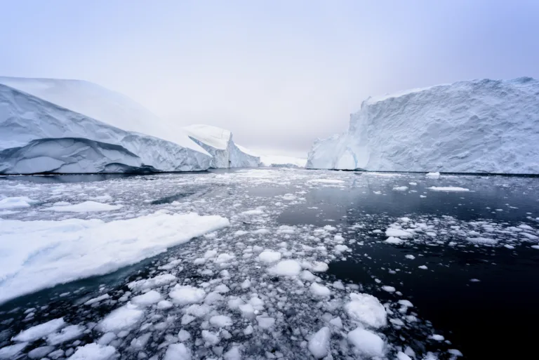 Arctic Icebergs in the clean arctic sea. On this image you can easily see that 1/10th of an iceberg is over the water surface, and 9/10th is below the water surface. Sometimes unbelievable that 90% of an iceberg is under water. West Greenland, 70 Degrees North.