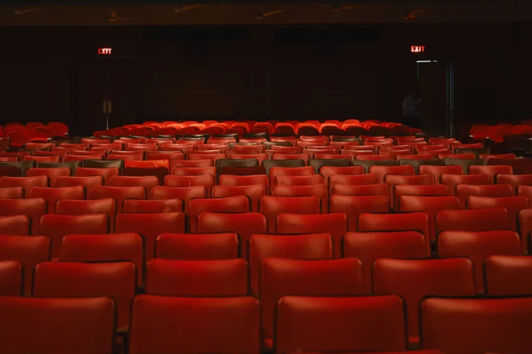 Empty red seats in a vintage movie theater