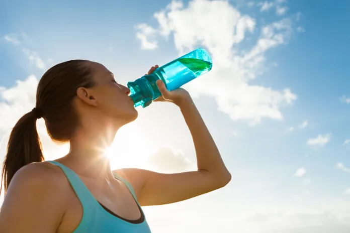 female-drinking-a-fresh-water-from-bottle-stockpack-istock Female drinking a fresh water from bottle.