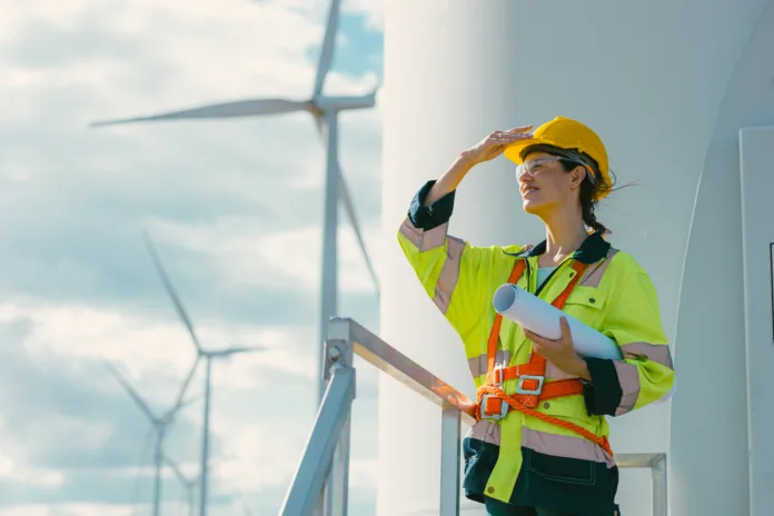 female-engineer-working-outdoor-with-safety-at-wind-turbines-clean-energy-power-station-background-worker-people-with-renewable-energy-technology-for-future-concept-stockpack-istock female engineer working outdoor with safety at wind turbines clean energy power station background, worker people with renewable energy technology for future concept.