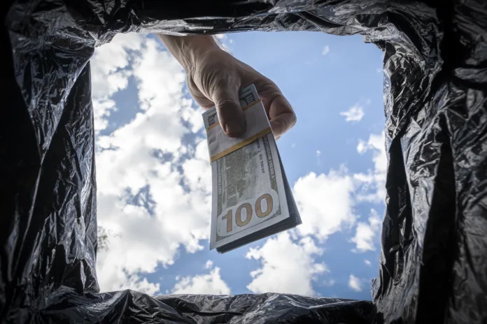getting-rid-of-excess-cash-switching-to-non-cash-payment-the-concept-of-inflation-stockpack-istock Getting rid of excess cash, switching to non-cash payment. The concept of inflation.