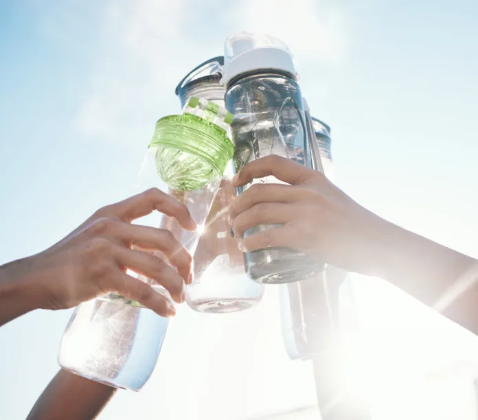 hands-water-bottle-and-toast-to-fitness-together-after-workout-exercise-or-training-outdoor-with-team-of-players-sport-goals-and-cheers-with-group-and-liquid-for-hydration-celebration-and-unity-stockpack-istock Hands, water bottle and toast to fitness together after workout, exercise or training outdoor with team of players. Sport, goals and cheers with group and liquid for hydration, celebration and unity
