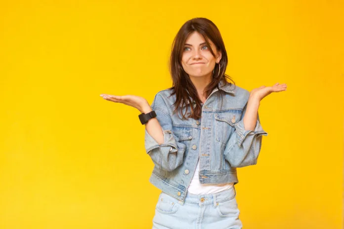 i-dont-know-portrait-of-confused-beautiful-brunette-young-woman-with-makeup-in-denim-casual-style-standing-with-raised-arms-looking-away-and-doubt-indoor-studio-shot-isolated-on-yellow-background-stockpack-istock I don't know. Portrait of confused beautiful brunette young woman with makeup in denim casual style standing with raised arms, looking away and doubt. indoor studio shot, isolated on yellow background