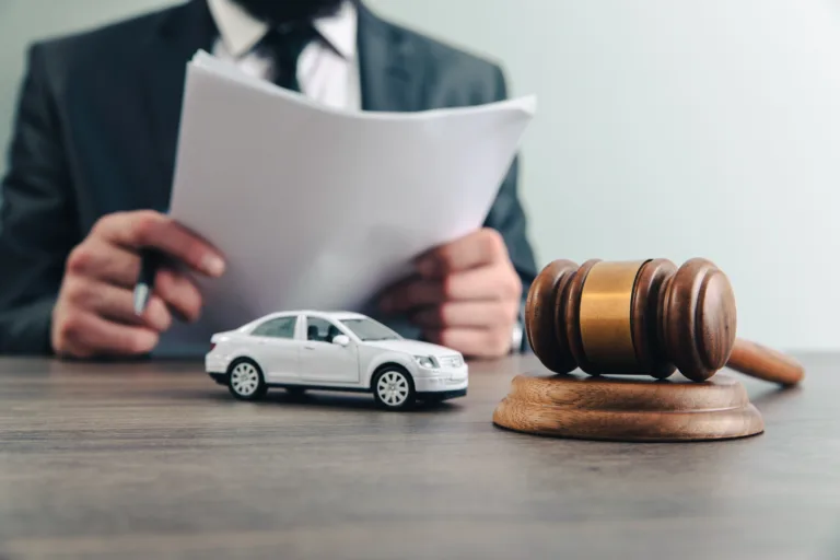 Judge with toy car and gavel on table