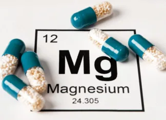Ni vsak magnezij enak: različne oblike prehranskega dopolnila imajo različne učinke Pills with mineral Mg (magnesium) on a white background with an inscription from the chemical table.