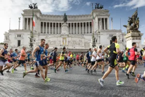 Rome, Italy - April 10, 2016: Athletes participating in the Rome Marathon in 2016 while crossing Piazza Venezia, in the background the famous Vittoriano monument.